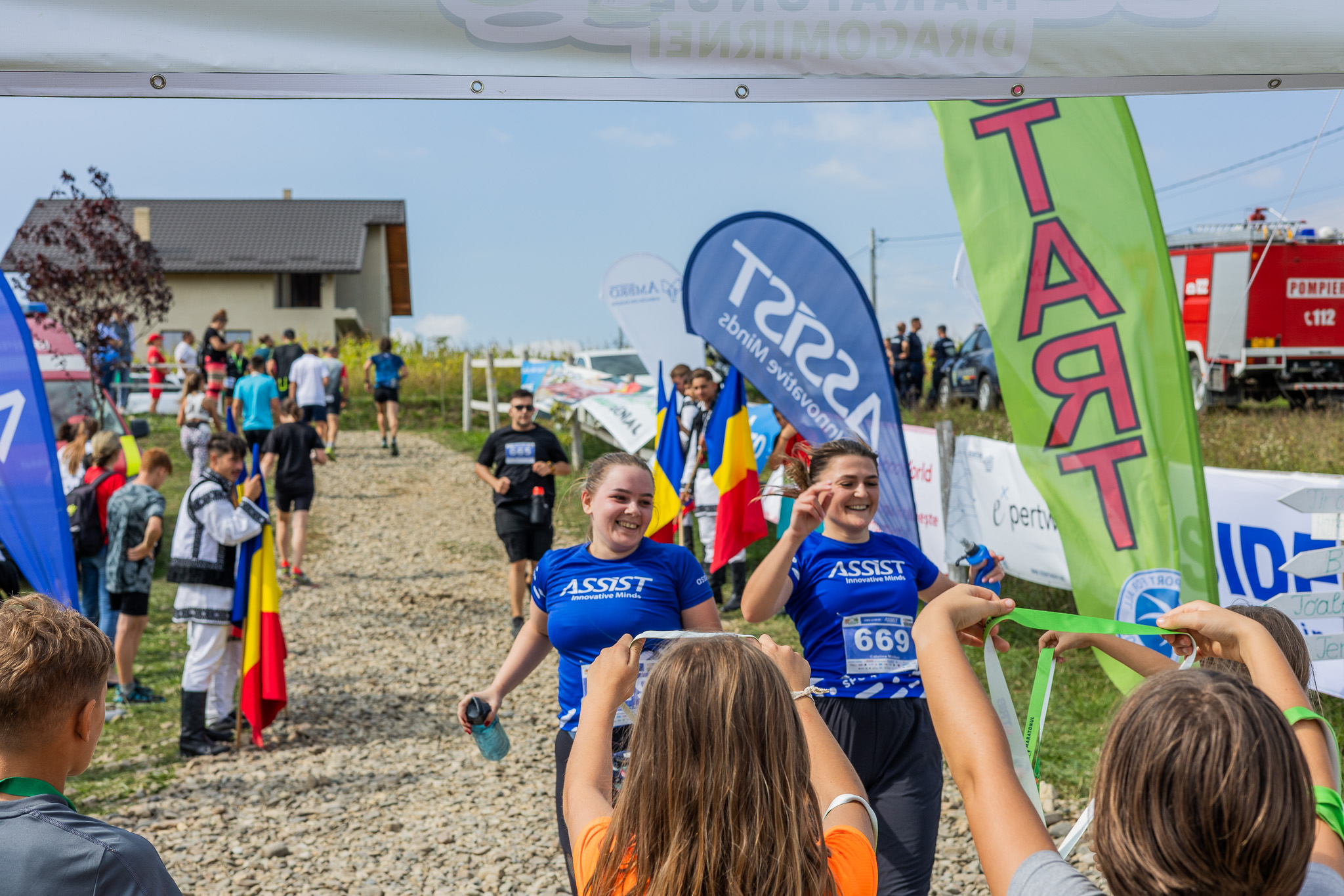 Two members of the ASSIST Software team, crossing the finish line