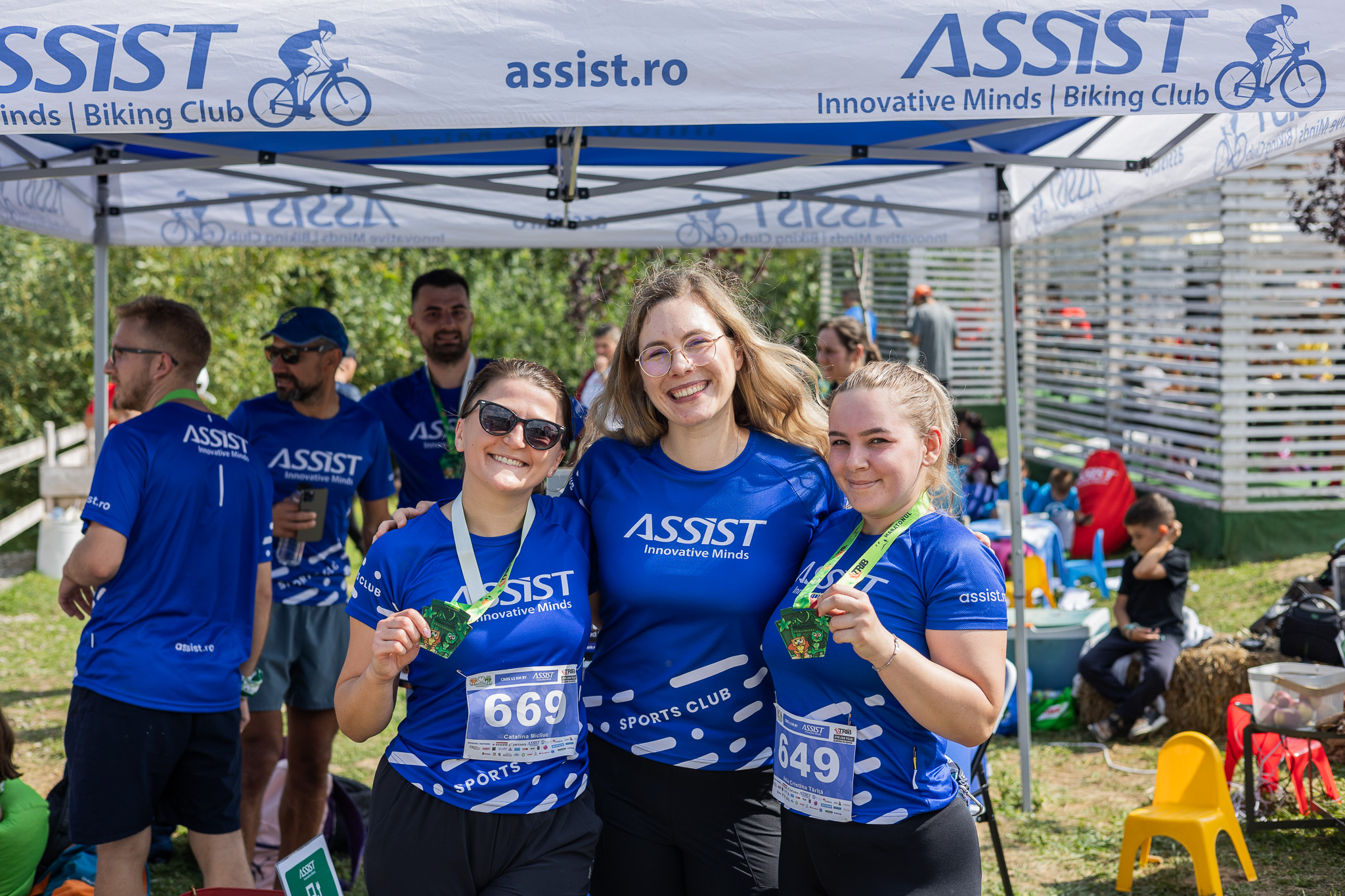 ASSIST Software team members showing their medals